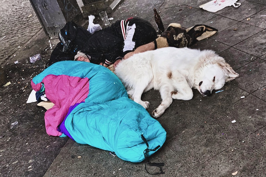 Homeless people with dog in Berlin, Alexanderplatz.