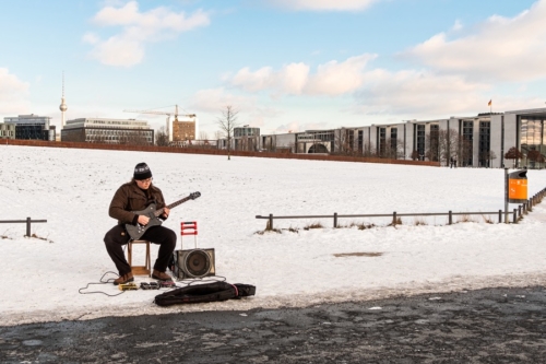 Street musician in Berlin in winter. Street musician in Berlin in winter.