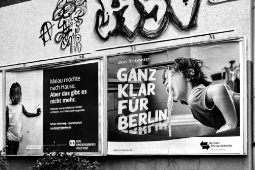 Plakate von SOS Kinderdorf und den Berliner Wasserwerken in Berlin Moabit zeigt Lebenswirklichen von Kindern